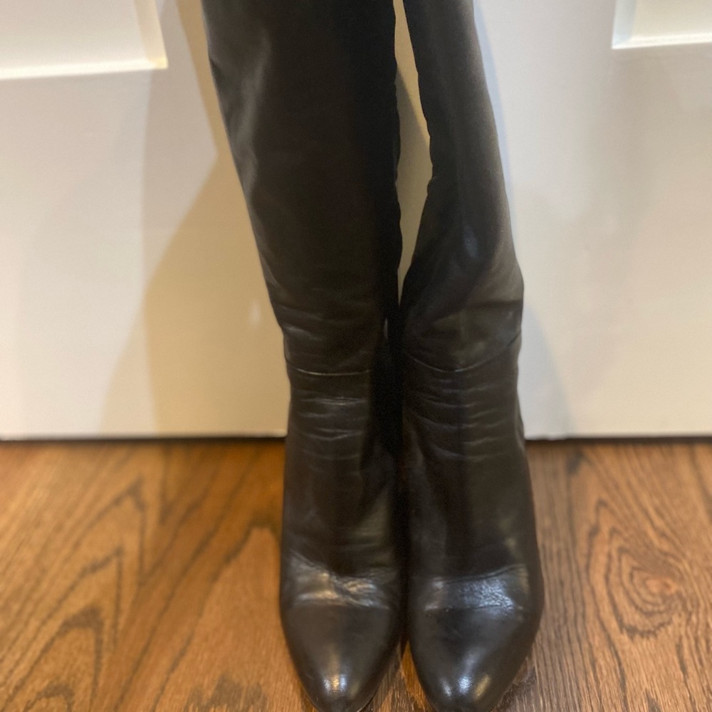 Barneys New York Black leather knee-high wedge heel boots.